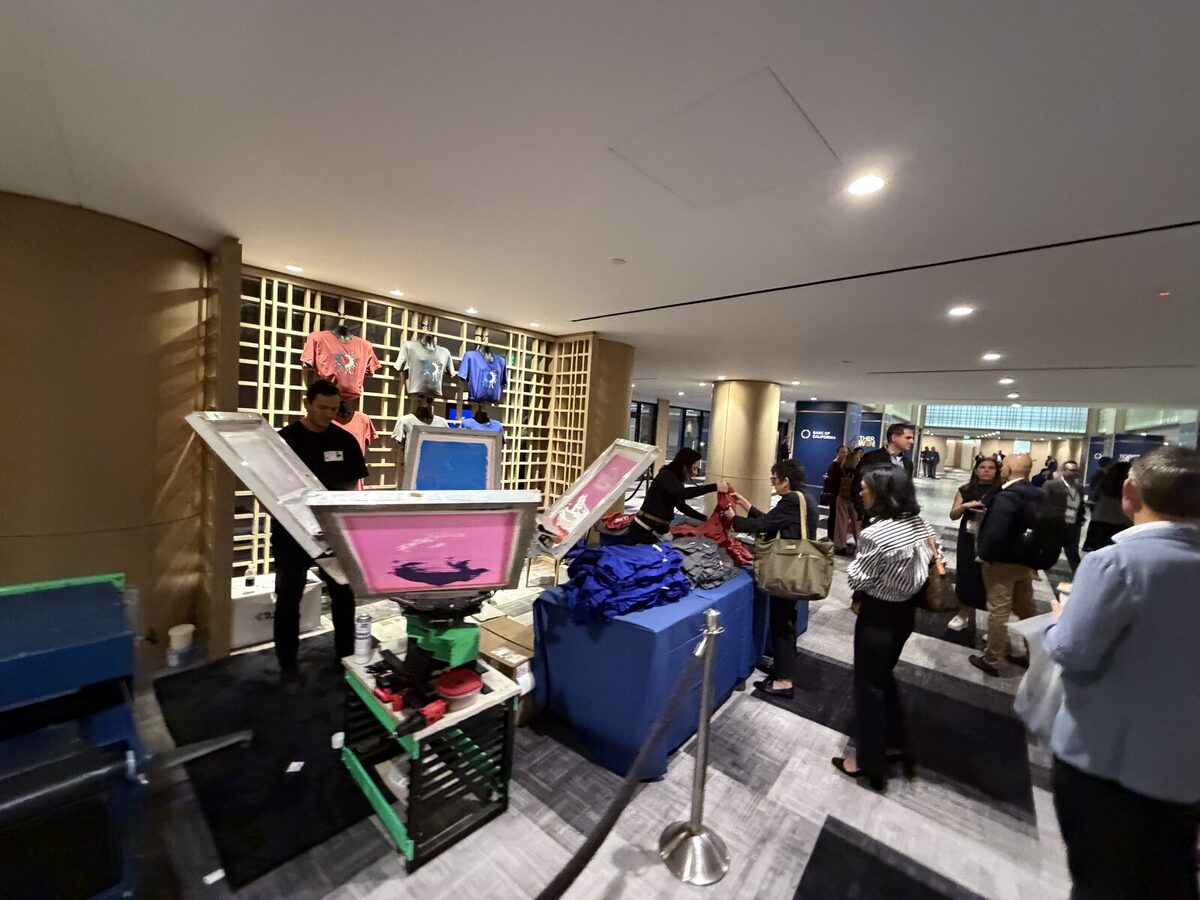 Crowd gathered around a live printing bar at an event